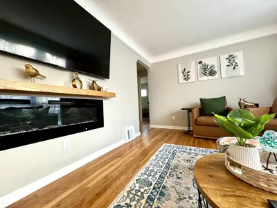 a living room with a large flat screen tv at Parma Ranch with Hot Tub and Game and Media Room in Parma