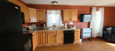 a kitchen with wooden cabinets and a sink and a stove at The Lake House in Hillsboro