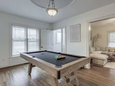 a living room with a pool table in it at Upscale Historic Home near Downtown, Hall of Fame, Beach, Arenas in Cleveland