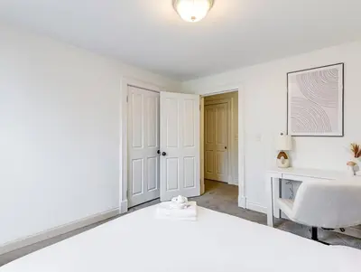 a white bedroom with a bed and a desk at Upscale Historic Home near Downtown, Hall of Fame, Beach, Arenas in Cleveland