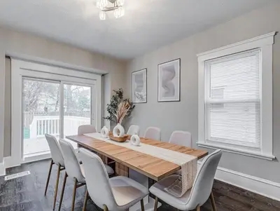 a dining room with a wooden table and chairs at Upscale Home near Downtown Cle, R&R HoF, Beach, Arena in Cleveland