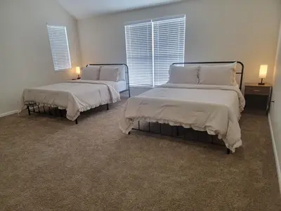 a bedroom with two beds and a window at Charming 4BR New Home Columbus With Garage Parking in Columbus