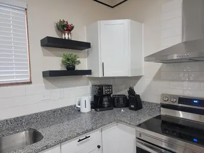 a kitchen with white cabinets and a counter top at Charming 4BR New Home Columbus With Garage Parking in Columbus