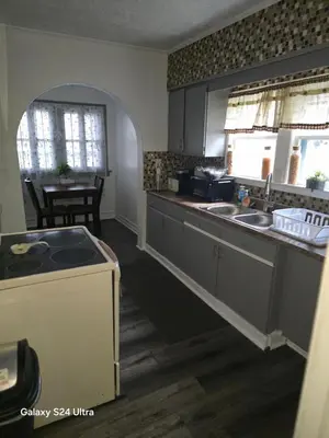 a kitchen with a sink and a counter top at Leisure guest home in Lorain
