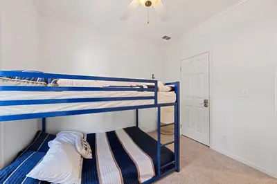 two bunk beds in a room with a ceiling fan at Lake Erie Serenity Hutch in Port Clinton