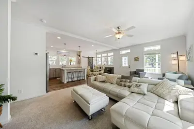 a living room with a white couch and a kitchen at Lake Erie Serenity Hutch in Port Clinton