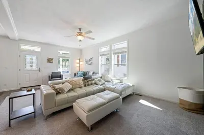 a living room with a couch and a ceiling fan at Lake Erie Serenity Hutch in Port Clinton