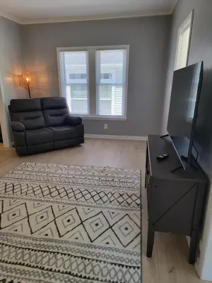 a living room with a couch and a television at Lake Erie Beach Hutch in Port Clinton