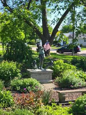 a statue of a girl holding an american flag at Lake Erie Beach Hutch in Port Clinton