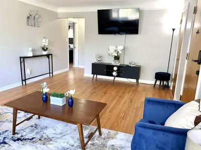 a living room with a blue couch and a table at 30day Conveniently Located in a Quiet Suburb in Cincinnati