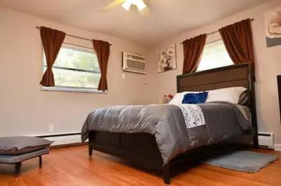 a bedroom with a large bed and two windows at 30day Conveniently Located in a Quiet Suburb in Cincinnati