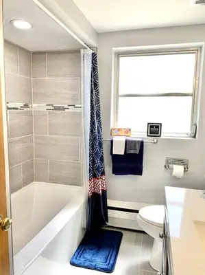 a bathroom with a tub and a toilet and a window at 30day Conveniently Located in a Quiet Suburb in Cincinnati