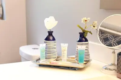 two vases sitting on a tray on a bathroom counter at 30day Conveniently Located in a Quiet Suburb in Cincinnati