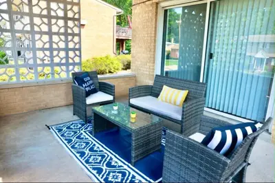 a patio with wicker chairs and a table on a porch at 30day Conveniently Located in a Quiet Suburb in Cincinnati
