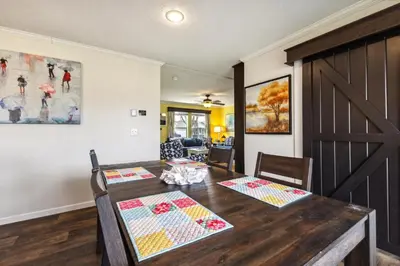 a dining room with a wooden table with two chairs at Sunsets & Serenity- Port Clinton Waterfront Stay home in Port Clinton