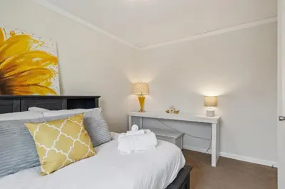 a bedroom with a bed and a desk with a lamp at Sunsets & Serenity- Port Clinton Waterfront Stay home in Port Clinton