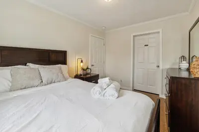 a bedroom with a white bed with towels on it at Sunsets & Serenity- Port Clinton Waterfront Stay home in Port Clinton