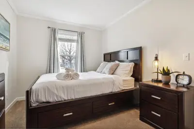 a bedroom with a large bed and a window at Sunsets & Serenity- Port Clinton Waterfront Stay home in Port Clinton