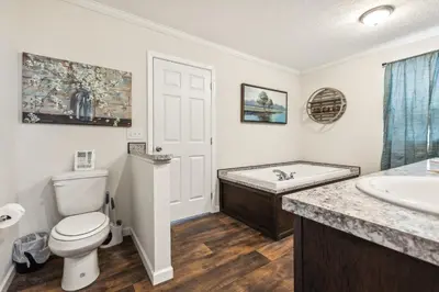 a bathroom with a toilet and a tub and a sink at Sunsets & Serenity- Port Clinton Waterfront Stay home in Port Clinton