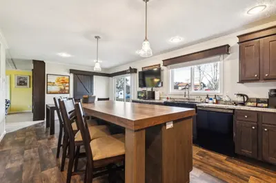 a kitchen with a large wooden table and chairs at Sunsets & Serenity- Port Clinton Waterfront Stay home in Port Clinton