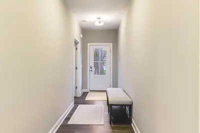 a hallway with a bench in front of a door at 24 Mi to Cincinnati Newly Built Bethel Home! in Batavia