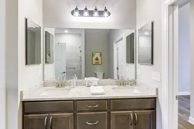 a bathroom with two sinks and two mirrors at 24 Mi to Cincinnati Newly Built Bethel Home! in Batavia