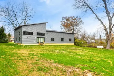 a large white building on a grass field at 24 Mi to Cincinnati Newly Built Bethel Home! in Batavia