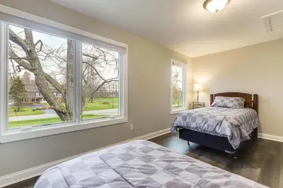 a bedroom with a bed and a large window at 24 Mi to Cincinnati Newly Built Bethel Home! in Batavia