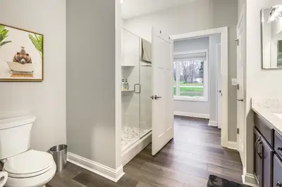 a bathroom with a toilet and a walk in shower at 24 Mi to Cincinnati Newly Built Bethel Home! in Batavia