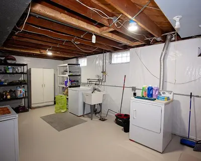 a garage with a room with white walls and white floors at Rosewood Ranch in Lakewood