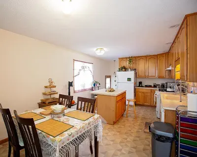 a kitchen with a table and a dining room at Rosewood Ranch in Lakewood