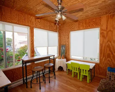 a room with a table and chairs and windows at Rosewood Ranch in Lakewood