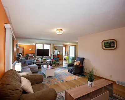a living room with a couch and a table at Rosewood Ranch in Lakewood