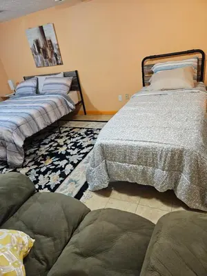 two beds sitting next to each other in a bedroom at Rosewood Ranch in Lakewood