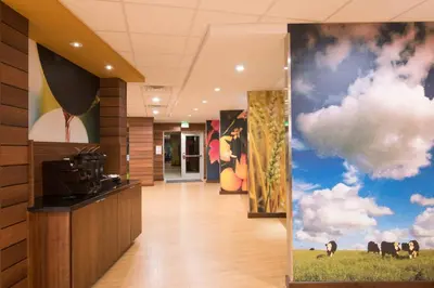 a hallway in a office with paintings on the walls at Fairfield Inn & Suites by Marriott Fort Wayne Southwest in Ellison
