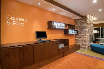 a hotel lobby with a computer on a wall at Fairfield Inn & Suites by Marriott Fort Wayne Southwest in Ellison