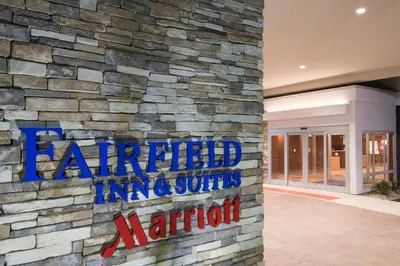 a stone wall with a sign on a building at Fairfield Inn & Suites by Marriott Fort Wayne Southwest in Ellison