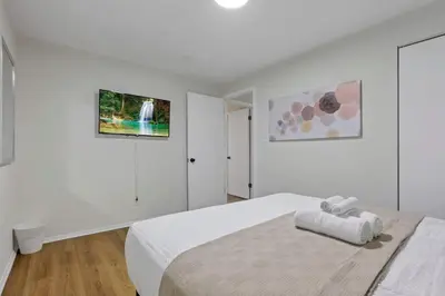 a white bedroom with a large white bed in it at The Reynoldsburg Getaway in Reynoldsburg