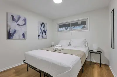 a white bedroom with a large bed in it at The Reynoldsburg Getaway in Reynoldsburg