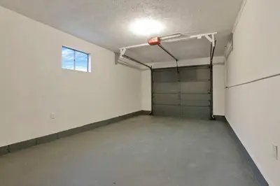 an empty garage with a garage door and a window at The Reynoldsburg Getaway in Reynoldsburg