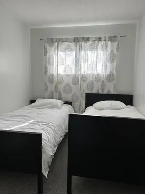 a bedroom with two beds and a window at The House On Kings Corner in Mansfield