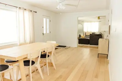 a kitchen and dining room with a wooden table and chairs at The House On Kings Corner in Mansfield