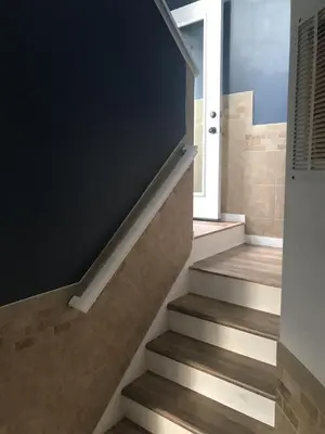 a staircase in a house with a black wall at Papa & Gigi's Lake Front Home in Port Clinton