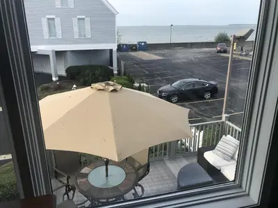 a view of a balcony with an umbrella and a car at Papa & Gigi's Lake Front Home in Port Clinton