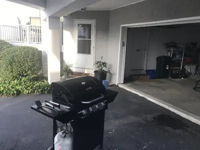 a grill in front of a house with a garage at Papa & Gigi's Lake Front Home in Port Clinton