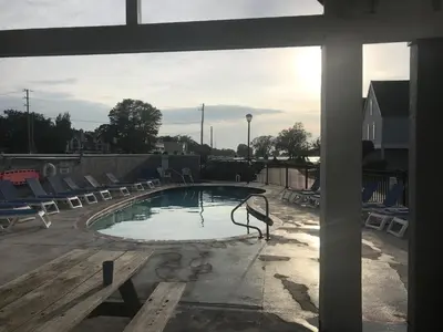 an empty swimming pool with chairs around it at Papa & Gigi's Lake Front Home in Port Clinton