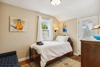 a bedroom with a bed and a window at The Henry House I Pet Friendly Cozy Convenient in Fairview Park