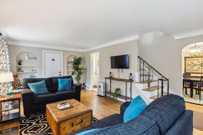 a living room with two couches and a tv at The Henry House I Pet Friendly Cozy Convenient in Fairview Park