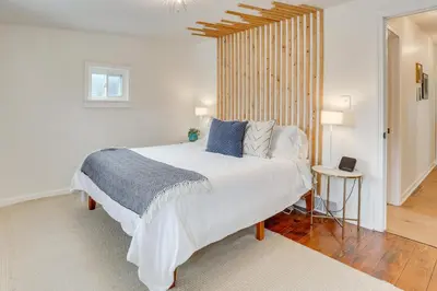a bedroom with a large white bed with blue pillows at Patio and Lake Views Family-Friendly Canton Retreat in Canton