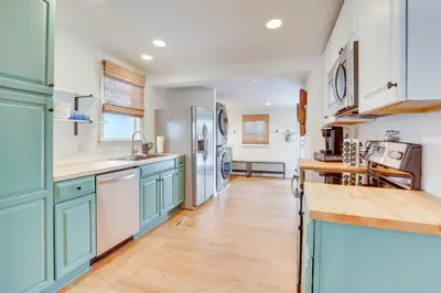 a kitchen with blue cabinets and a wooden floor at Patio and Lake Views Family-Friendly Canton Retreat in Canton